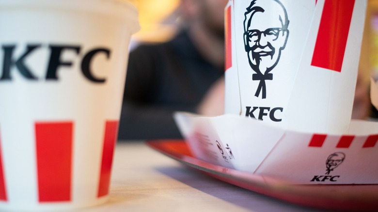 Several containers from KFC featuring The Colonel Sanders logo