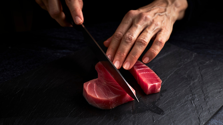 chef cutting tuna for sushi