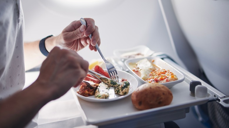 passenger eating on plane