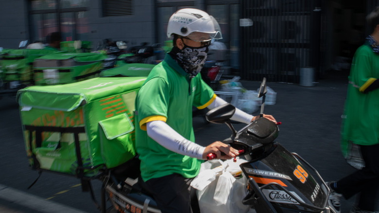 Food delivery worker on scooter