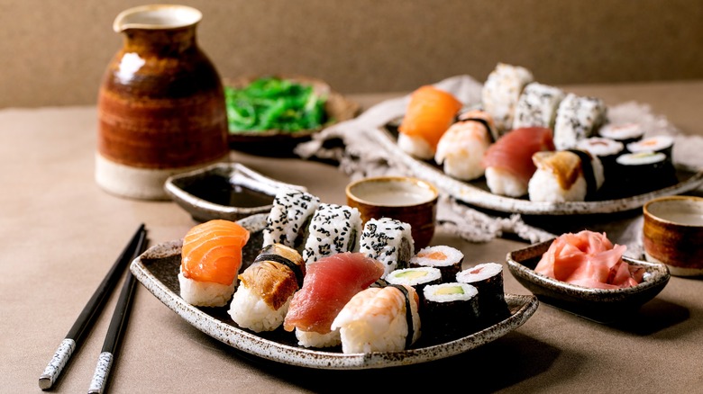 sake and plates of sushi