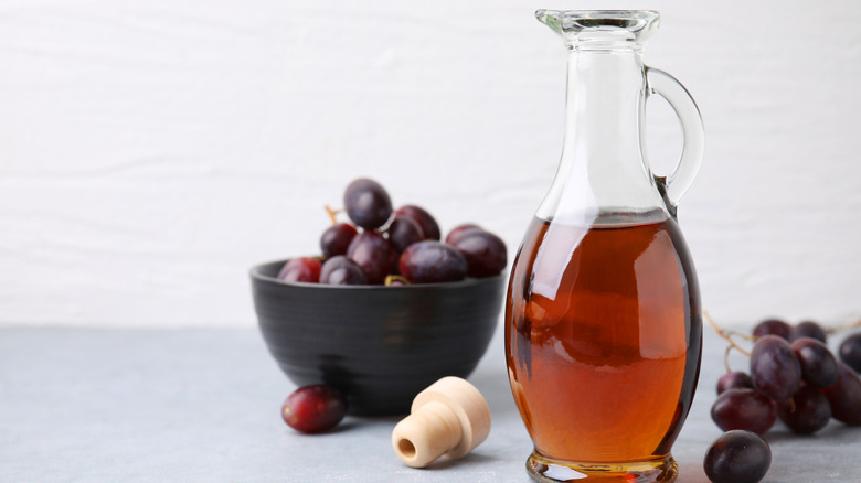 white vinegar in glass jug with grapes