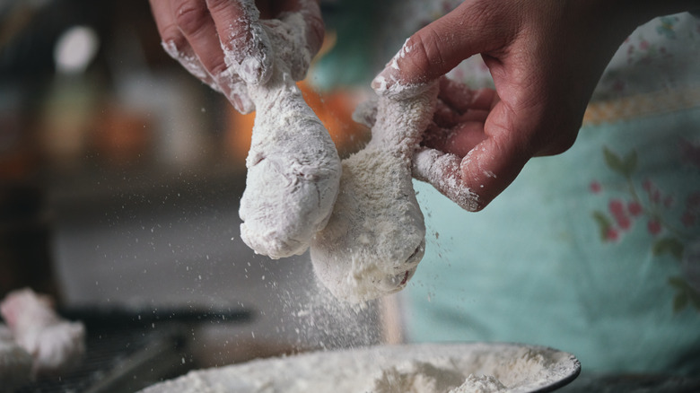 Coating drumsticks with flour