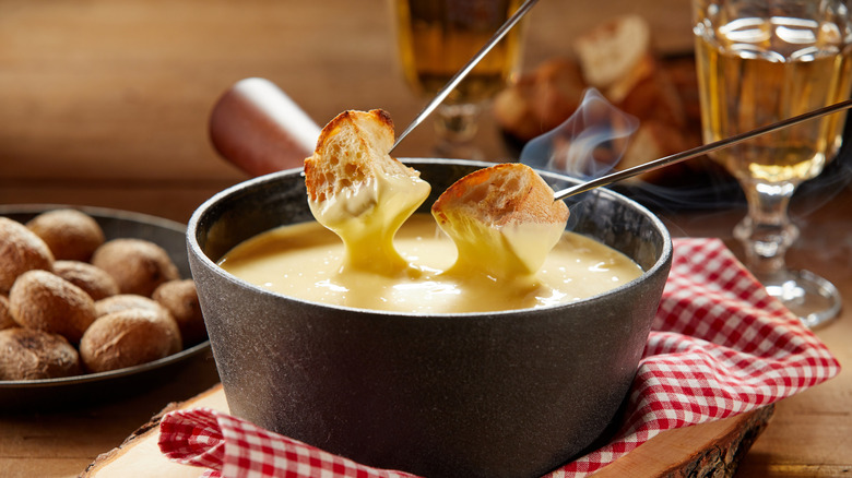 bread dipping into cheese fondue
