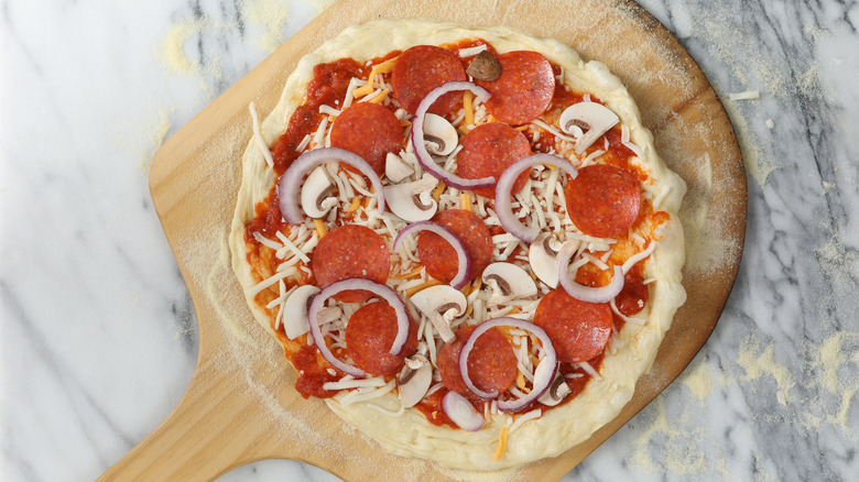 Pepperoni pizza on peel