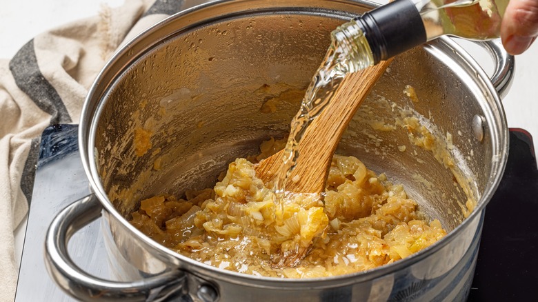 Adding wine to a pot of caramelized onions