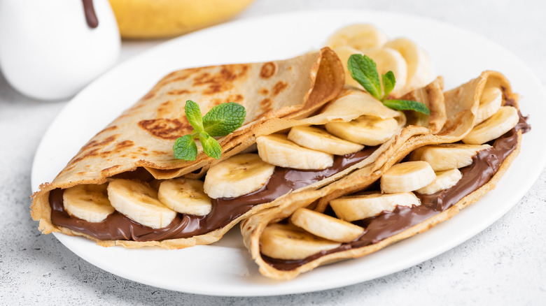 Crepes with chocolate filling on plate