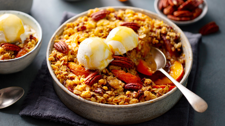 A bowl of peach pecan cobbler