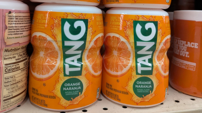 Containers of Tang drink powder on store shelf
