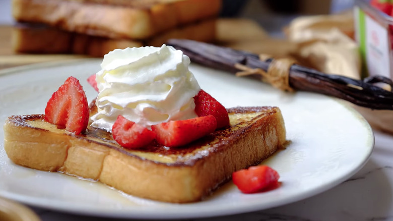 french toast topped with berries and whipped cream