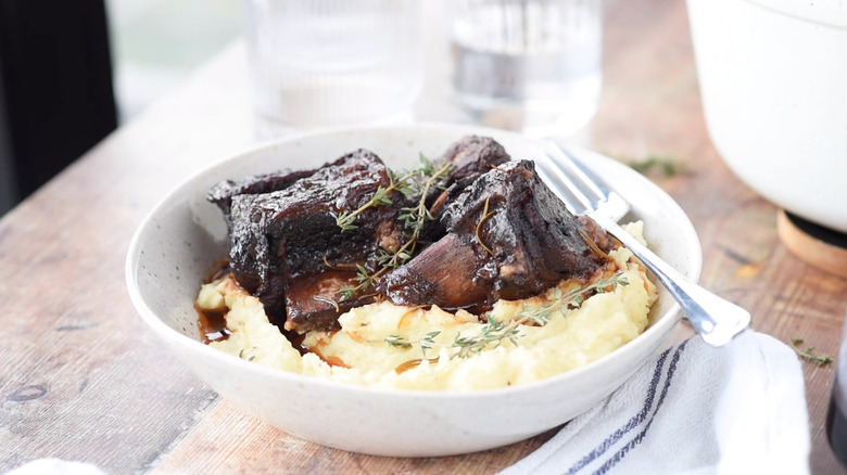 braised short rib on white and blue plate