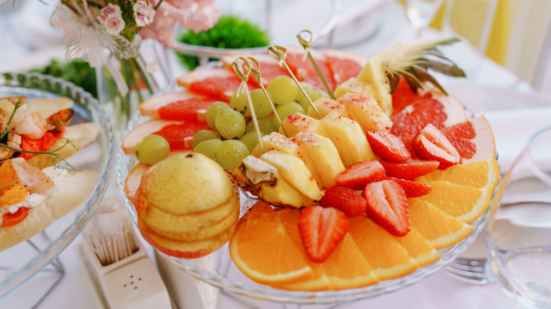 A plastic fruit platter at party
