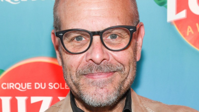 Alton Brown smiles with glasses in close-up