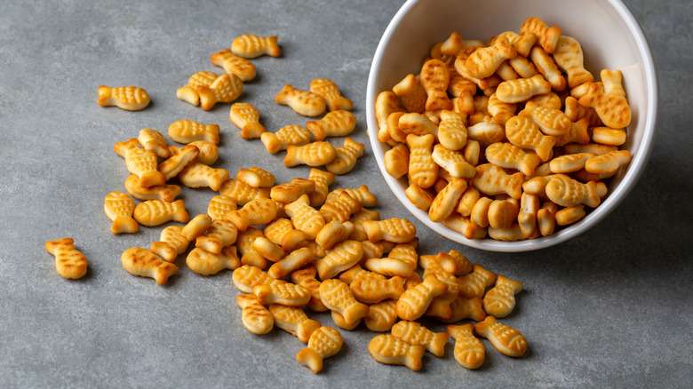 goldfish-shaped crackers spilling out of a titled bowl