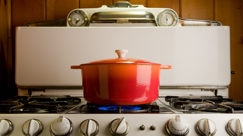 Pot of food cooking on antique stove
