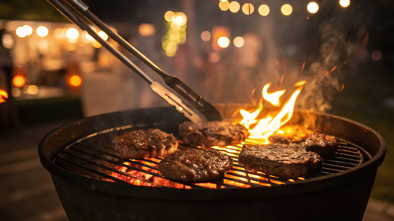 Burgers cooking on an outdoor grill