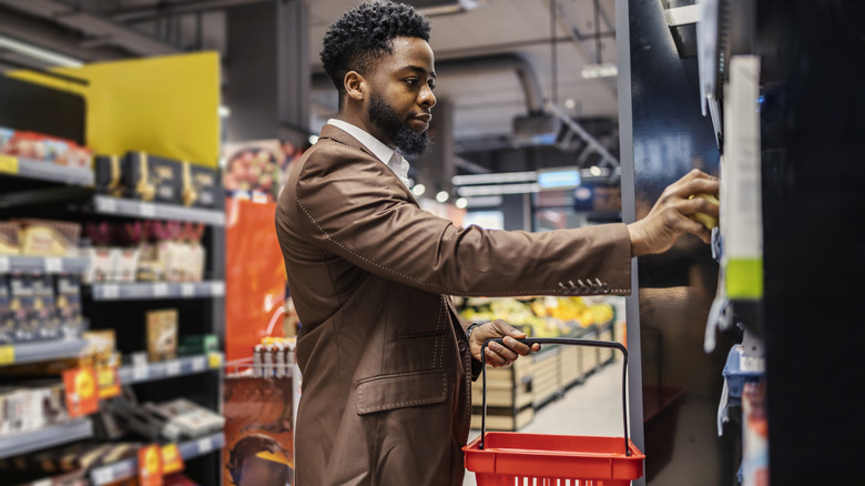 Foodie grocery shopping with a red basket