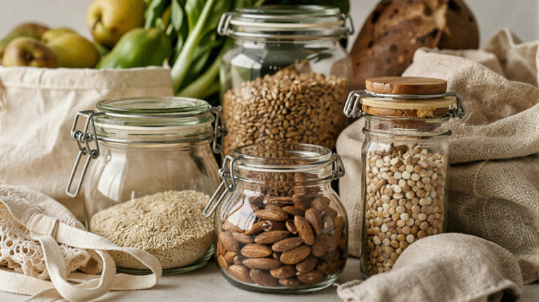 Almonds, lentils, rice, and seeds are stored in glass jars.