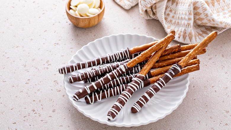 plate of chocolate-covered pretzel rods