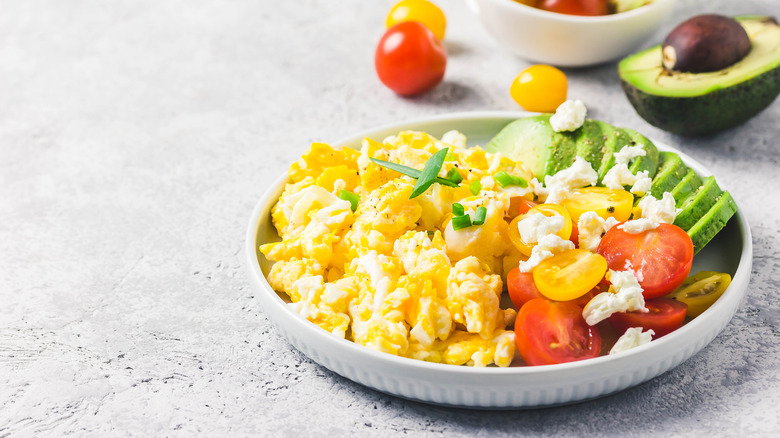 fluffy scrambled eggs with tomatoes avocado