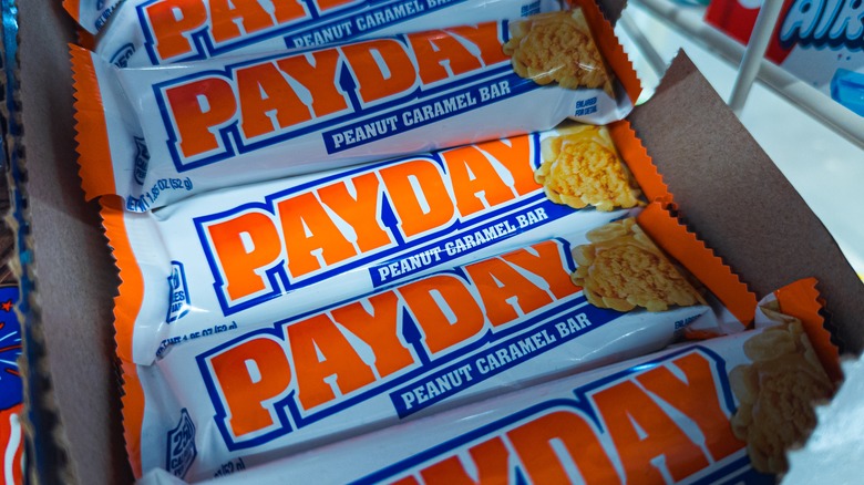 A closeup of a Payday candy bar wrapper against a white background