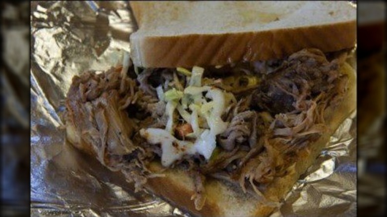 Close-up of a pulled pork sandwich on foil