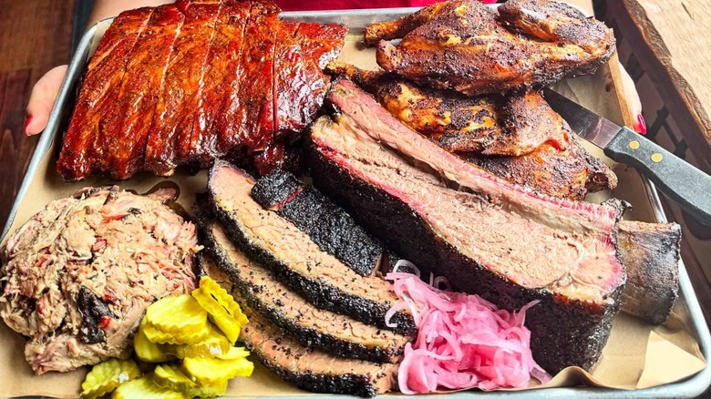 Tray with brisket, ribs, pulled pork, and smoked chicken