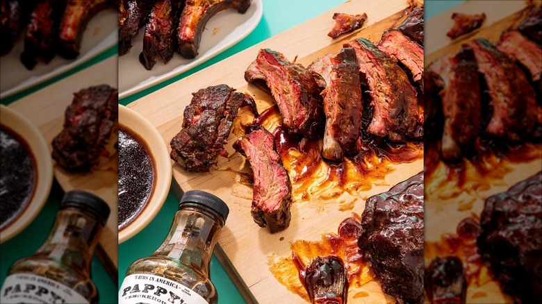 Sauce-covered ribs on a wooden cutting board