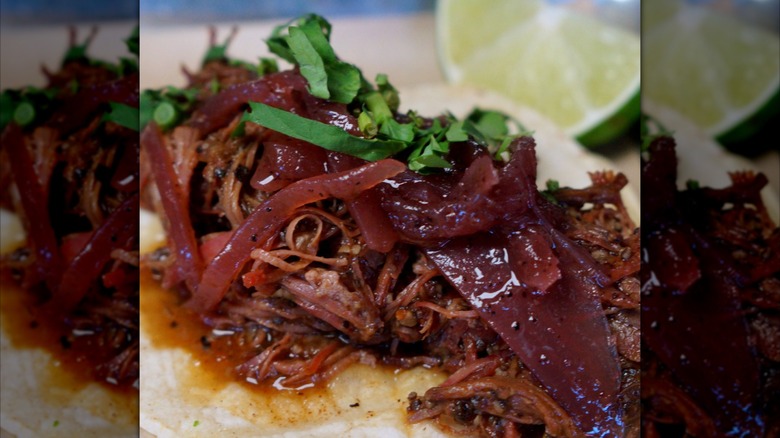 BBQ taco with onions and a lime slice