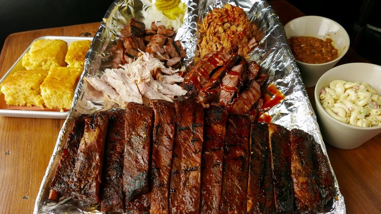 BBQ platter with ribs, chicken, pulled pork, and sides