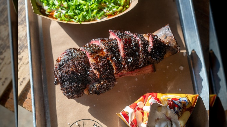 Beef rib and sides on a tray in the sunlight
