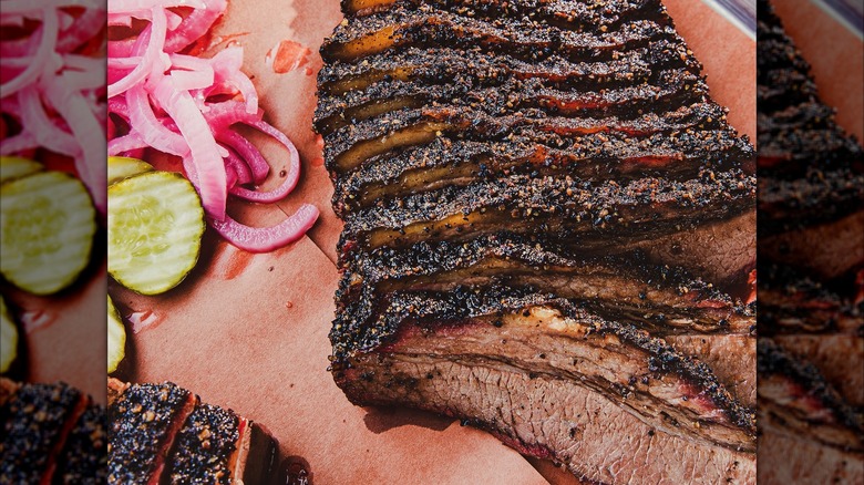 Slices of beef brisket with onions and pickles