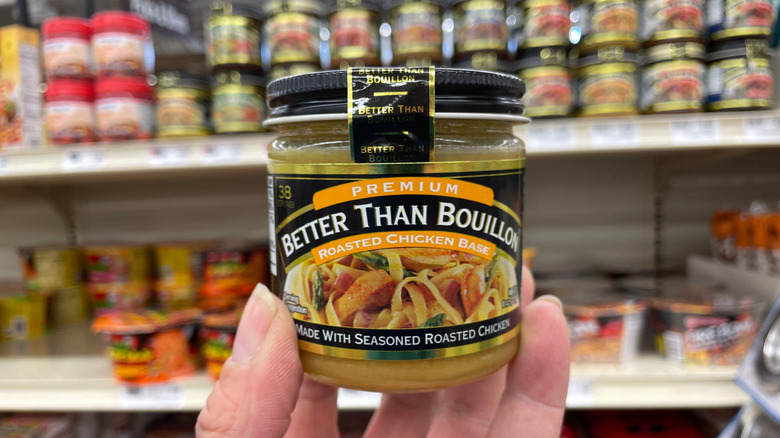 A person holds up a jar of roast chicken Better Than Bouillon