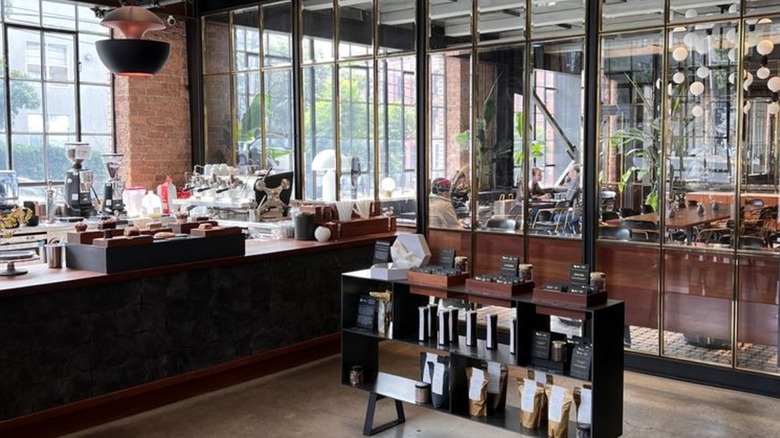 Interior of Dandelion Chocolate store, showing seating area, bar, and products on shelf