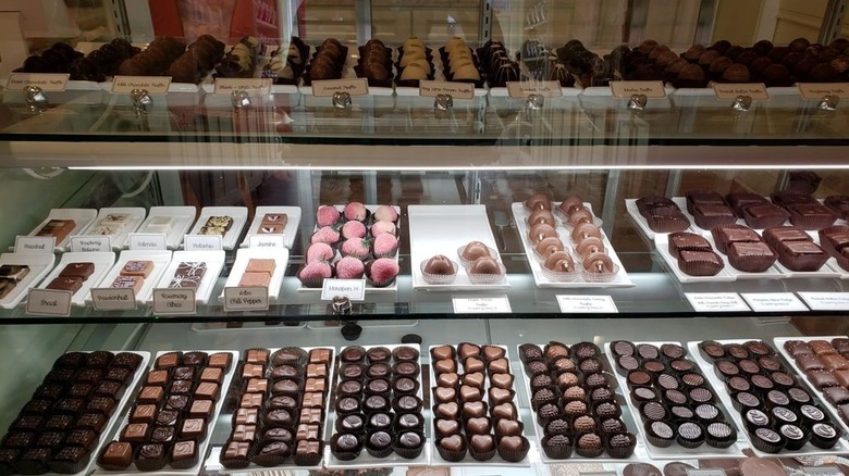 Various chocolate confections in glass display case