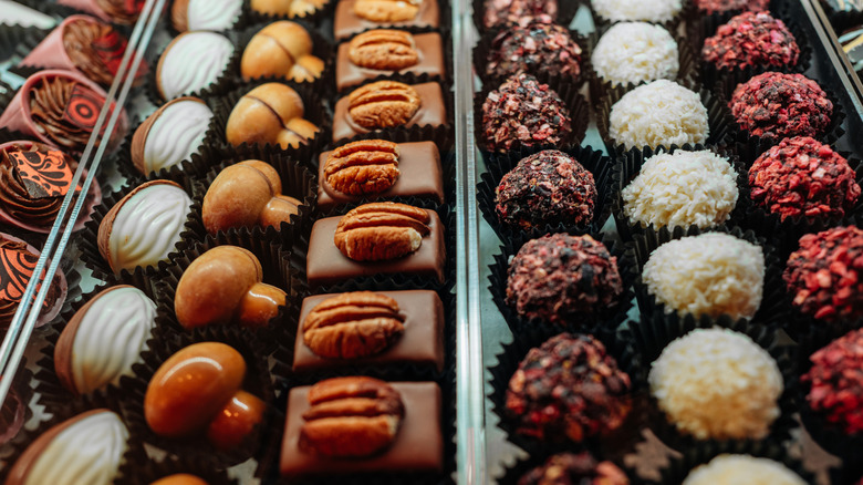 Variety of truffles and confections in case at chocolate shop