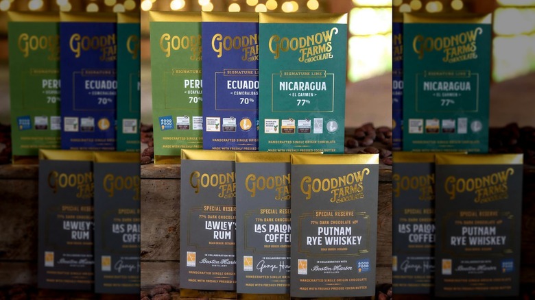 Six award-winning chocolate bars displayed alongside cacao beans