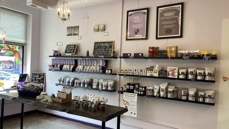Various chocolate products displayed on shelves along with informational posters