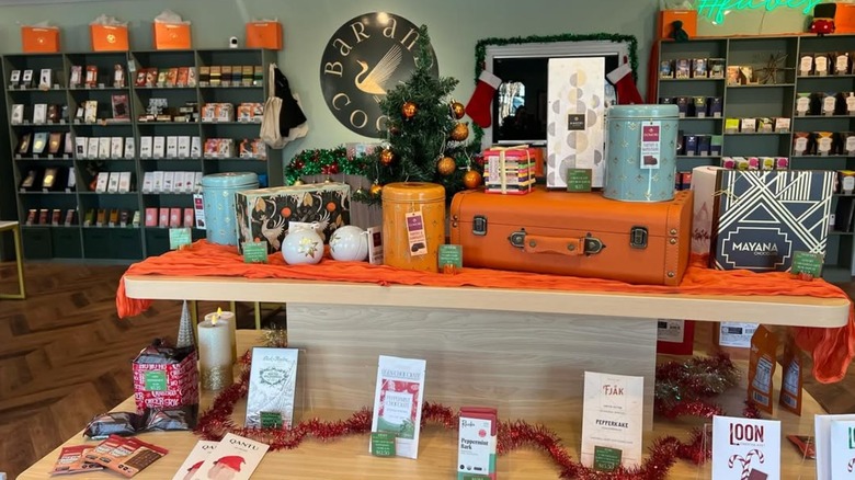 Bars from various high-end chocolate brands on display alongside holiday decor