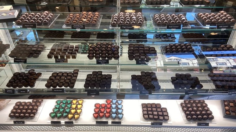 Glass display case filled with myriad types of chocolate confections