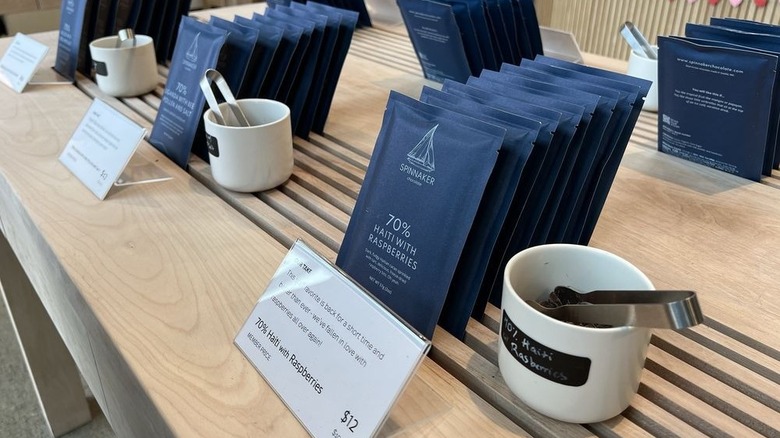Chocolate bars and samples on wooden table