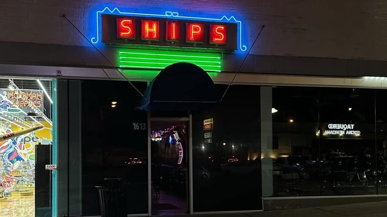 Neon-lit entrance of Ships Lounge at night