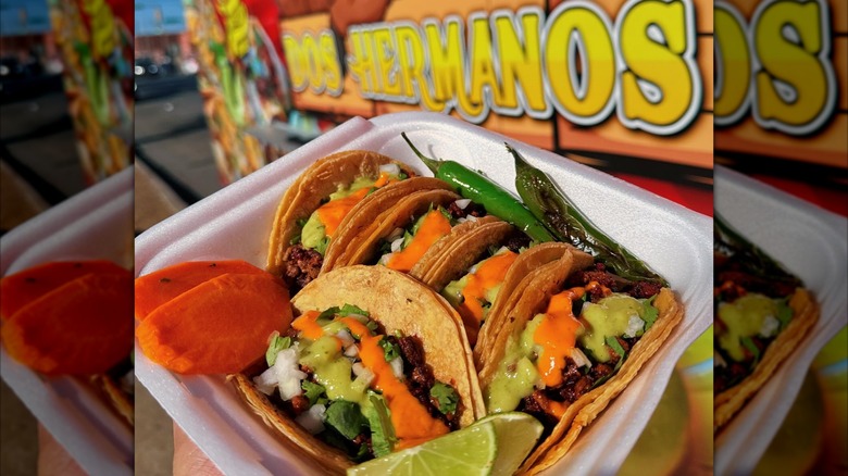 Container of tacos outside in front of Dos Hermanos taco truck