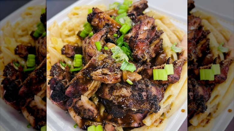 Grilled chicken on pasta in container