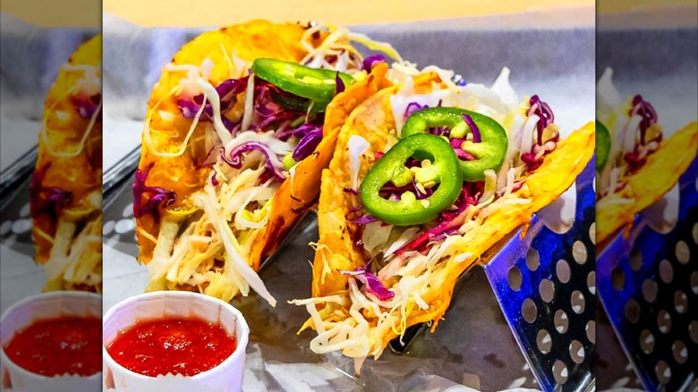 Two tacos with fresh slaw and salsa