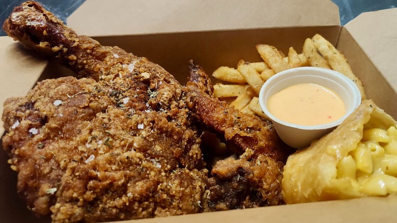 Box with fried chicken, fries, and mac and cheese chimichanga