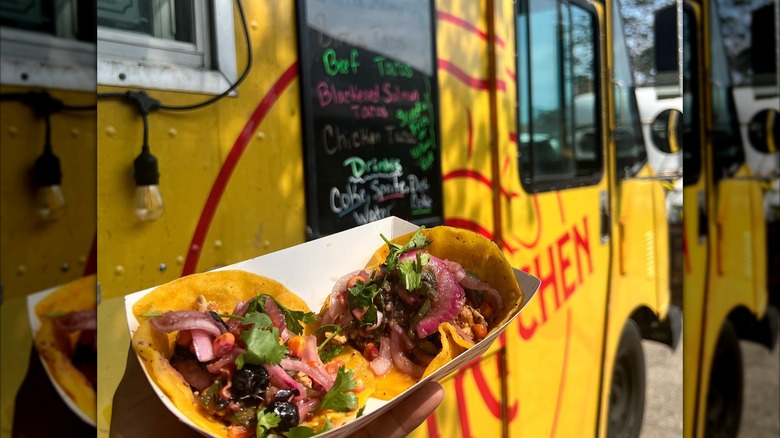 Tacos in container in front of food truck