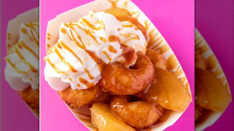 Mini donuts with apples, whipped cream, and caramel drizzle