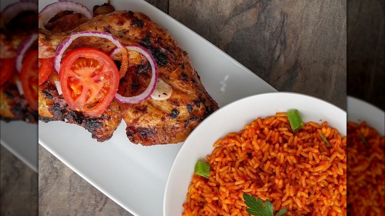 BBQ chicken with tomato and onion and dish of rice