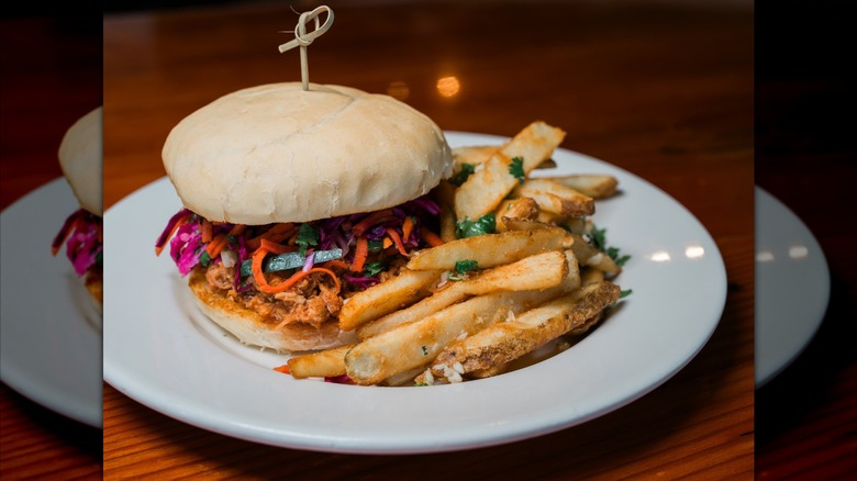 Burger and fries on white plate at Bear Tooth in Alaska